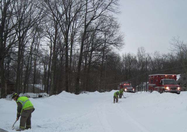 Squad 4-9's crew shoveling a driveway, so Ambulance 4-9's crew can access the patient; February 2010