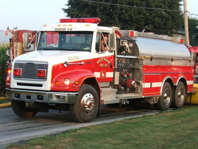 Chief Engineer Todd Steinmetz getting ready to offload Tanker 4-9's water at a barn fire drill on Old Leacock Road in Gordonville, 2005