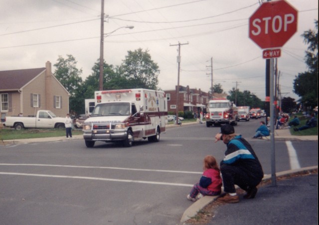 Ashley & Rodney Gossert watch Ambulance 4-9 & Tanker 4-9 approach during the 1997 Lancaster County parade in New Holland