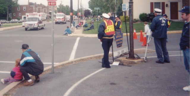 Station 4-9 members and children watch the 4-9 units in the 1997 County parade. L to R: Ashley and Rodney Gossert, unknown New Holland Fire Policeman, Mark Beyer, Andrew Flexer, Ross Parmer, John Flexer, and Tim Gossert